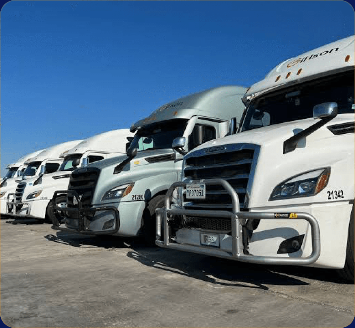Gillson Trucking fleet of white semi-trucks parked at a depot