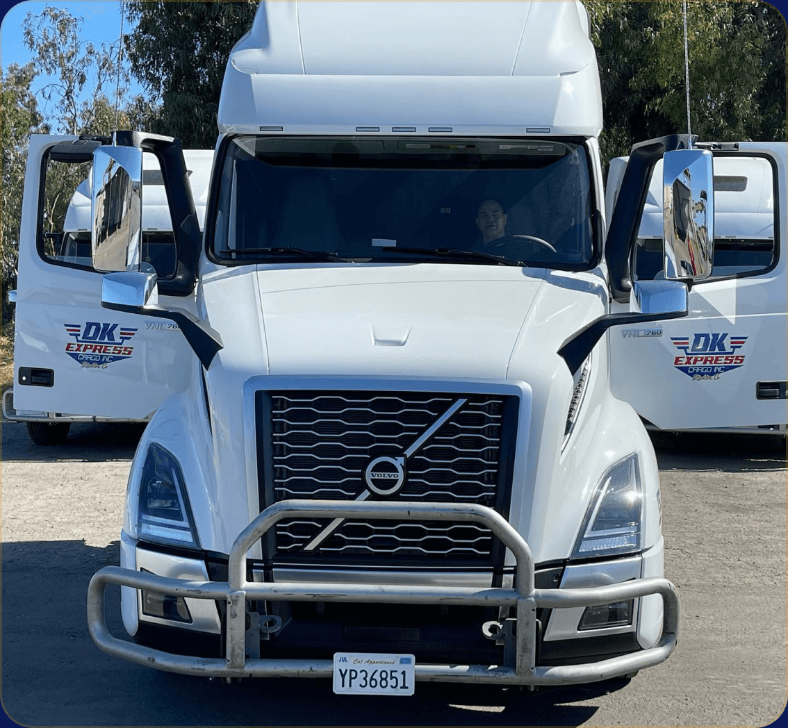 DK Express Cargo white Volvo semi-truck parked outdoors